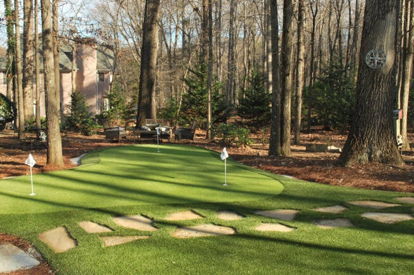 Flagstaff backyard putting green with flags and trees